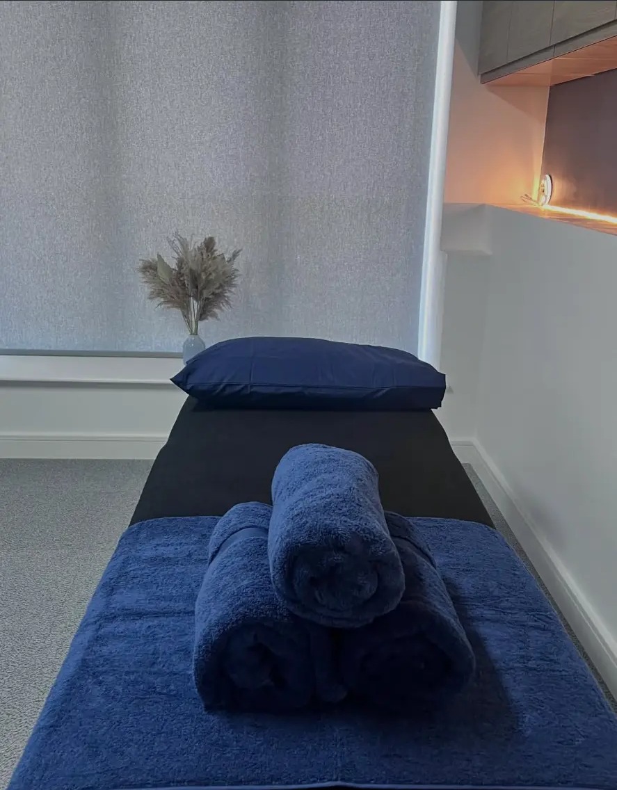 Fresh folded towels on the treatment couch